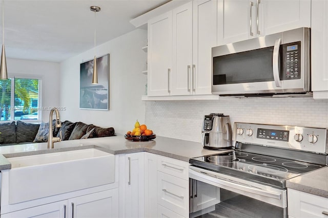 kitchen featuring open shelves, a sink, decorative backsplash, stainless steel appliances, and white cabinets