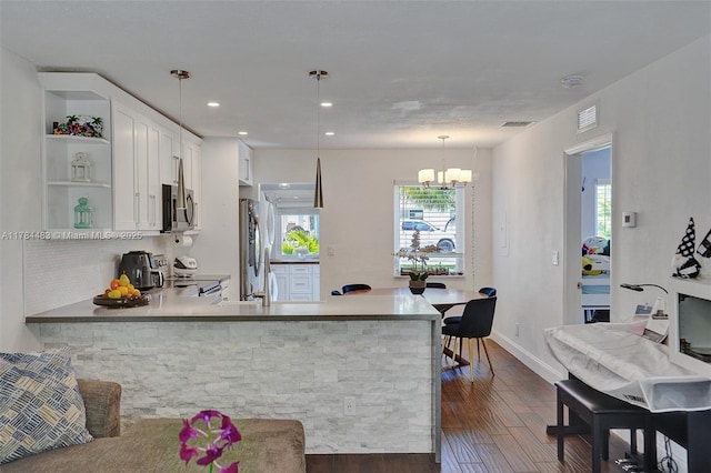 kitchen with open shelves, white cabinets, an inviting chandelier, stainless steel appliances, and dark wood finished floors