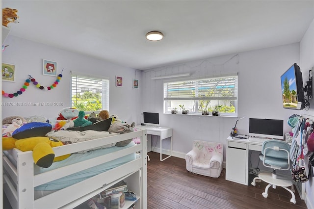 bedroom featuring baseboards and dark wood-type flooring