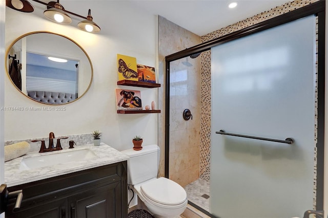 bathroom featuring a shower stall, toilet, vanity, and recessed lighting