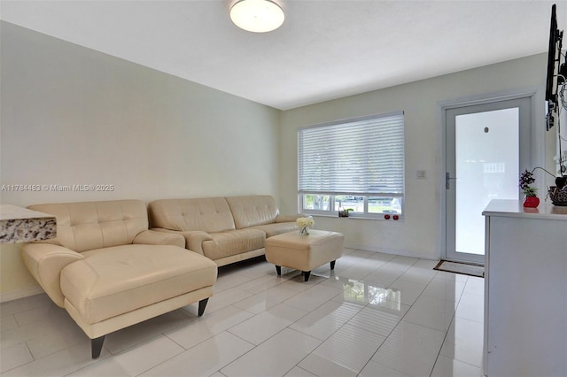living area with baseboards and light tile patterned flooring