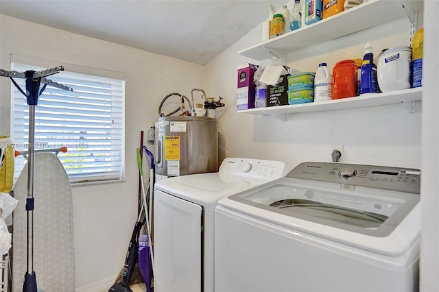 laundry room with laundry area, washing machine and clothes dryer, and electric water heater