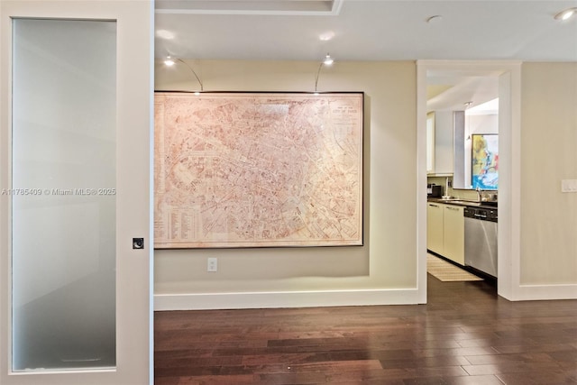 interior space with dark wood-style flooring and baseboards