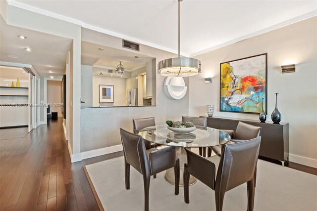 3340 NE 190th St Unit 504, Aventura, FL 33180 - dining area featuring wood-type flooring, baseboards, and a raised ceiling