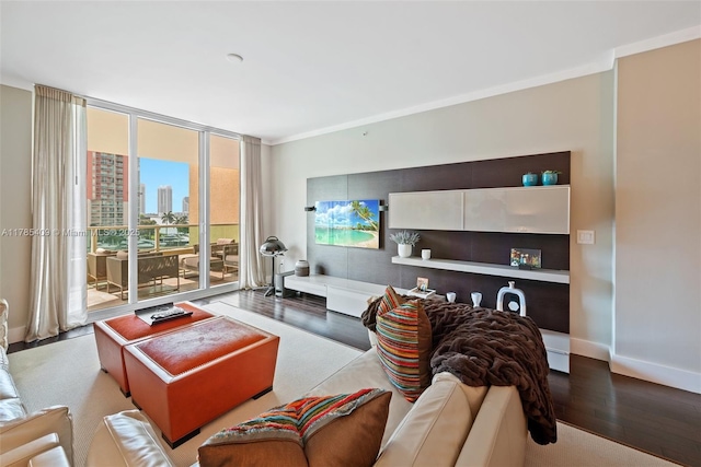 living area with baseboards, wood finished floors, and a wall of windows