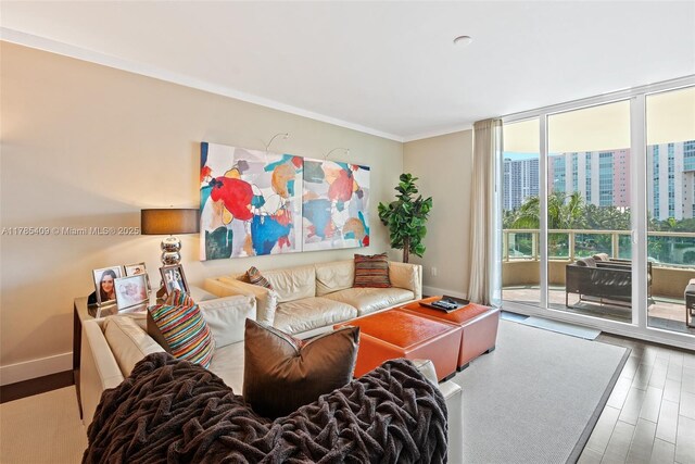 3340 NE 190th St Unit 504, Aventura, FL 33180 - living area featuring expansive windows, ornamental molding, wood finished floors, and baseboards