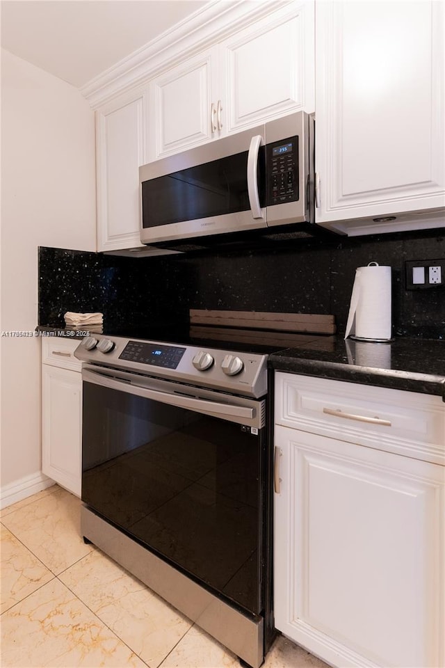 18011 Biscayne Blvd Unit 902, Aventura, FL 33160 - kitchen with appliances with stainless steel finishes, light marble finish flooring, white cabinetry, and tasteful backsplash