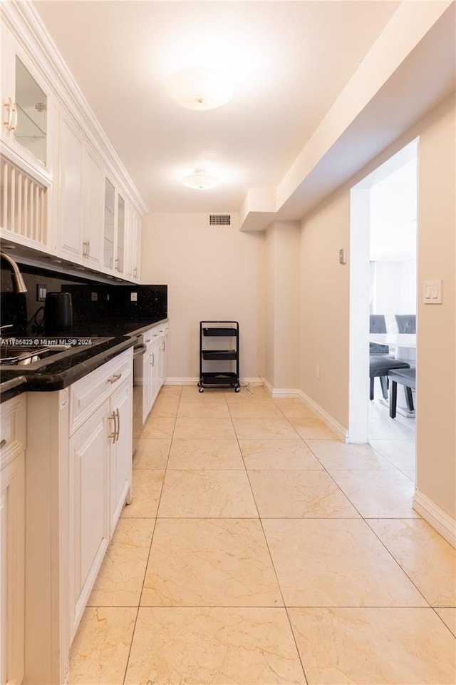 18011 Biscayne Blvd Unit 902, Aventura, FL 33160 - kitchen featuring dark countertops, light marble finish floors, glass insert cabinets, and a sink