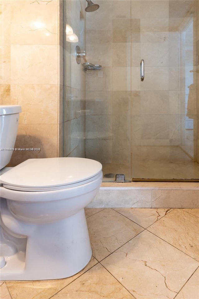 18011 Biscayne Blvd Unit 902, Aventura, FL 33160 - full bathroom with toilet, a shower stall, and tile walls