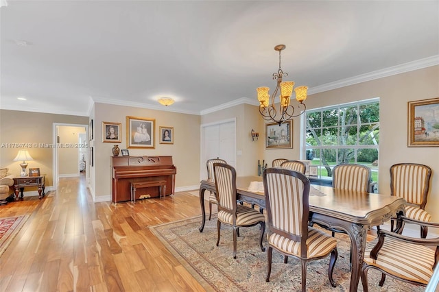 15801 SW 77th Ct, Palmetto Bay, FL 33157 - dining space with a chandelier, light wood-style floors, ornamental molding, and baseboards