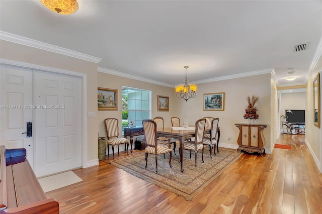 15801 SW 77th Ct, Palmetto Bay, FL 33157 - dining room with a chandelier, light wood finished floors, baseboards, and ornamental molding