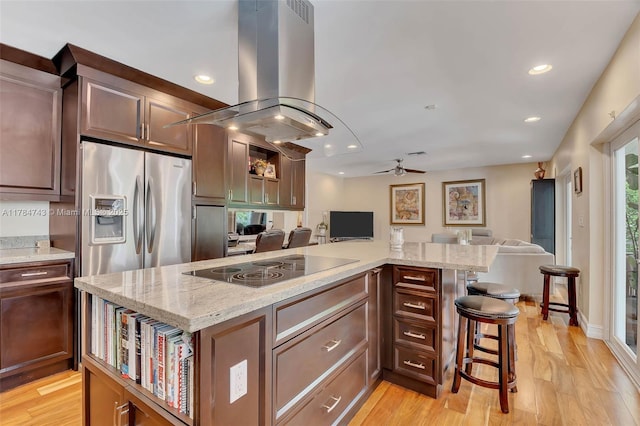 15801 SW 77th Ct, Palmetto Bay, FL 33157 - kitchen featuring island exhaust hood, open floor plan, stainless steel fridge with ice dispenser, ceiling fan, and light wood-type flooring