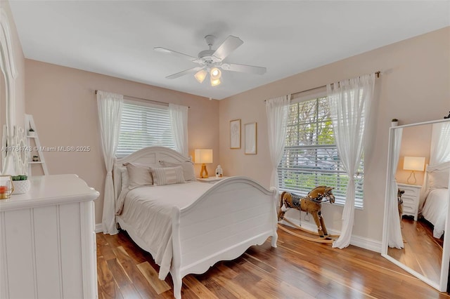 15801 SW 77th Ct, Palmetto Bay, FL 33157 - bedroom with light wood finished floors, baseboards, and a ceiling fan