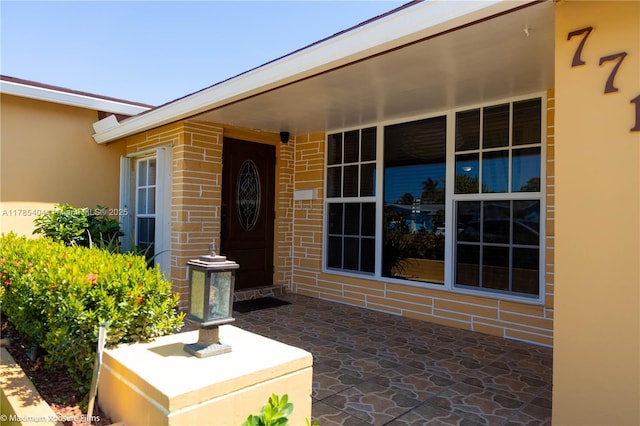property entrance with brick siding