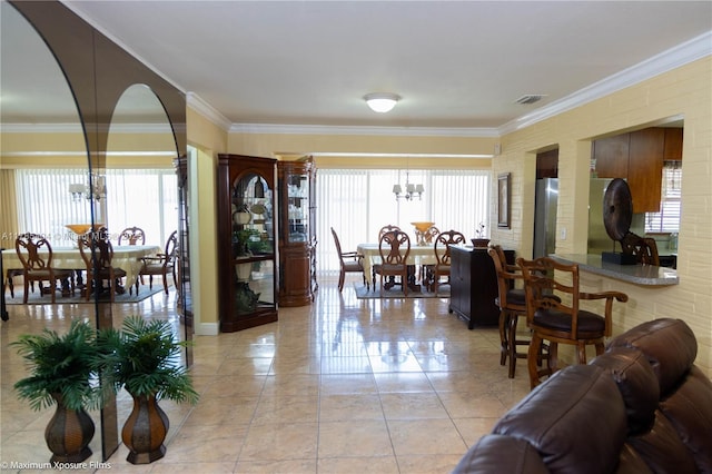 living area featuring a chandelier, crown molding, visible vents, and arched walkways