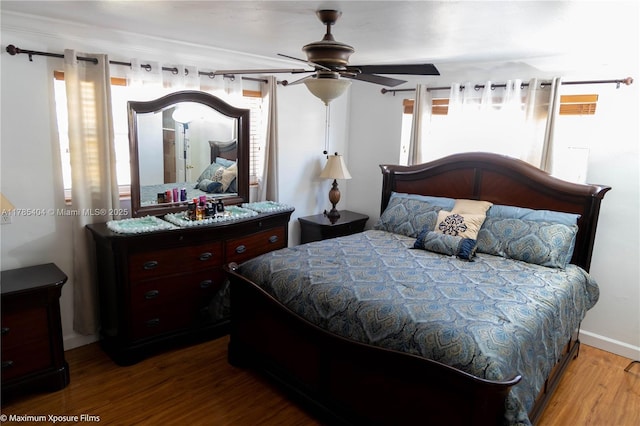 bedroom with a ceiling fan and wood finished floors