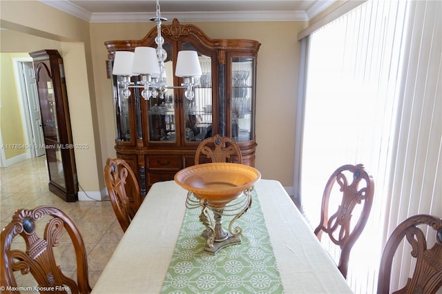 dining room with crown molding, a wealth of natural light, a chandelier, and baseboards