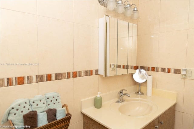 bathroom featuring vanity and tile walls
