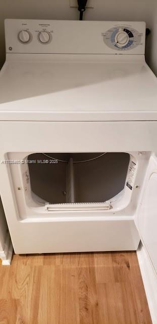 1919 Van Buren St Unit 520A, Hollywood, FL 33020 - detailed view of washer / clothes dryer and wood finished floors