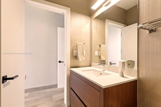 3581 E Glencoe St Unit 309, Miami, FL 33133 - bathroom featuring baseboards, vanity, and wood finished floors