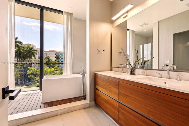 3581 E Glencoe St Unit 309, Miami, FL 33133 - full bathroom featuring a soaking tub, visible vents, tile patterned flooring, and a sink