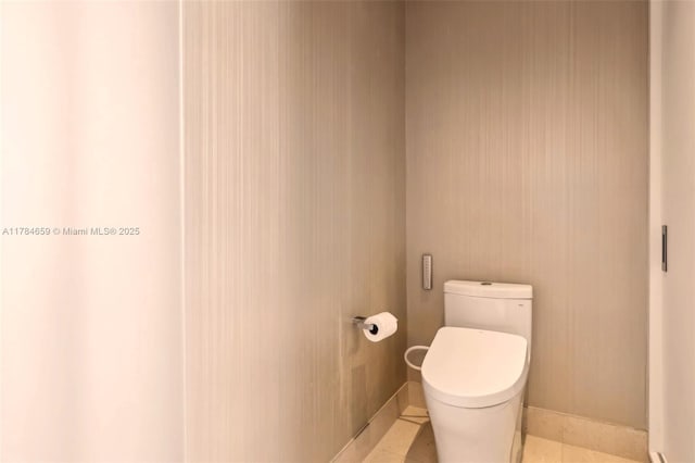 3581 E Glencoe St Unit 309, Miami, FL 33133 - bathroom featuring toilet, baseboards, and tile patterned floors