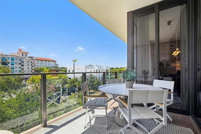 3581 E Glencoe St Unit 309, Miami, FL 33133 - balcony featuring visible vents and outdoor dining space