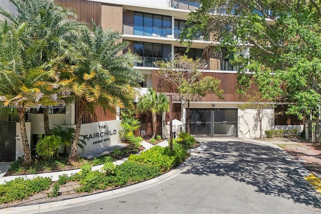 3581 E Glencoe St Unit 309, Miami, FL 33133 - view of building exterior with driveway and a garage