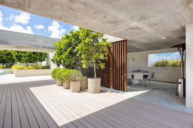 3581 E Glencoe St Unit 309, Miami, FL 33133 - wooden deck with outdoor dining space
