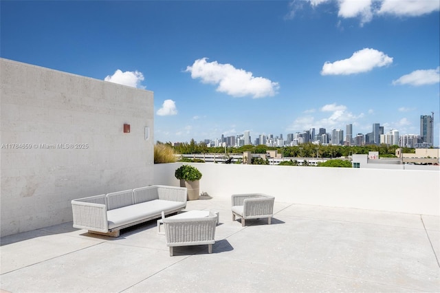 3581 E Glencoe St Unit 309, Miami, FL 33133 - view of patio / terrace with a skyline view and an outdoor living space