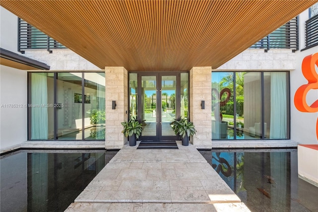 8825 SW 64th Ct, Pinecrest, FL 33156 - property entrance with french doors and stone siding