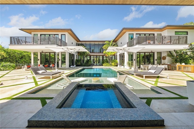 8825 SW 64th Ct, Pinecrest, FL 33156 - view of swimming pool with a patio, a pool with connected hot tub, and an outdoor living space