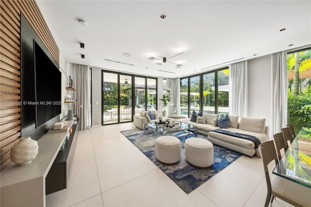 8825 SW 64th Ct, Pinecrest, FL 33156 - living area featuring floor to ceiling windows, healthy amount of natural light, and light tile patterned floors