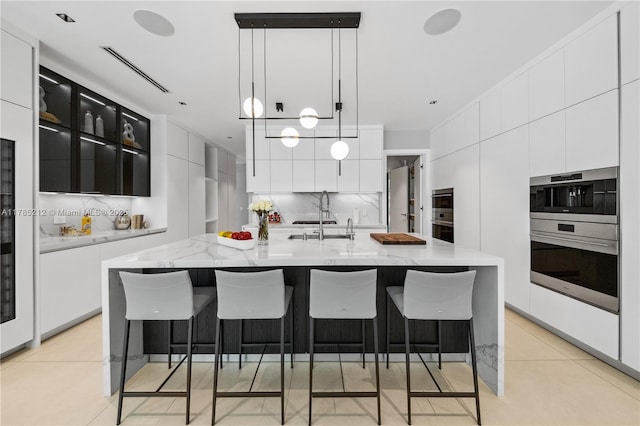 8825 SW 64th Ct, Pinecrest, FL 33156 - kitchen featuring a sink, white cabinetry, and modern cabinets