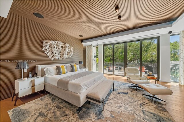 8825 SW 64th Ct, Pinecrest, FL 33156 - bedroom featuring access to outside, wood finished floors, and vaulted ceiling