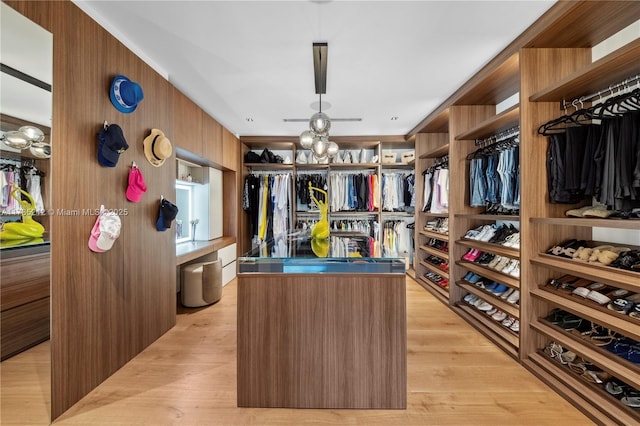 8825 SW 64th Ct, Pinecrest, FL 33156 - spacious closet with a chandelier and light wood-style flooring
