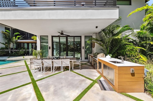 8825 SW 64th Ct, Pinecrest, FL 33156 - view of patio featuring an outdoor kitchen, a sink, a ceiling fan, outdoor dining space, and an outdoor pool