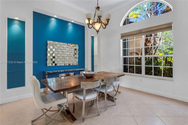 dining room with crown molding, baseboards, a notable chandelier, and light tile patterned flooring