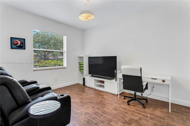 living area with wood finished floors and baseboards