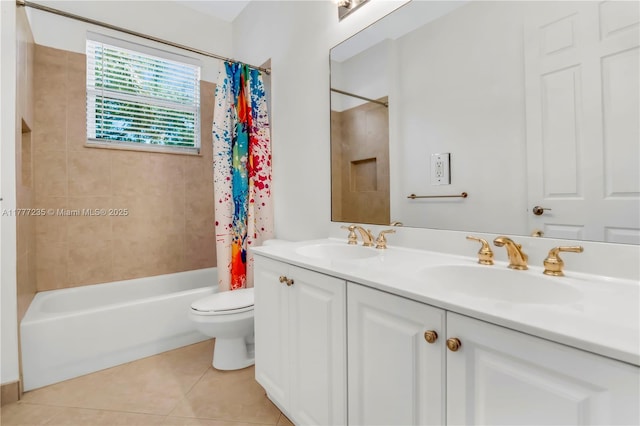 bathroom with a sink, tile patterned floors, toilet, and shower / tub combo