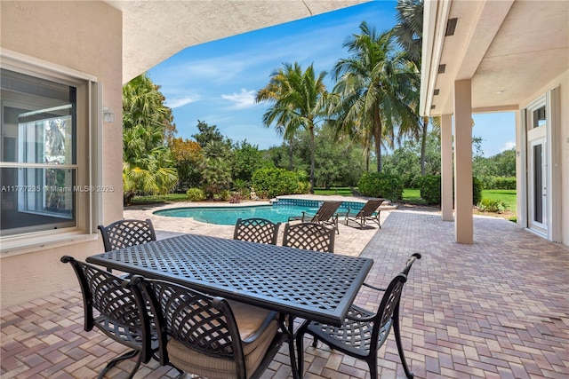 view of patio with an outdoor pool and outdoor dining space
