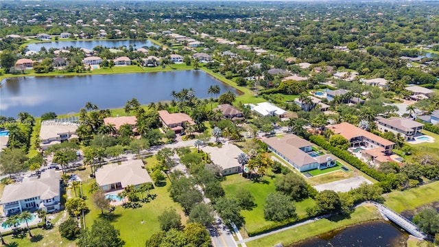 drone / aerial view featuring a residential view and a water view