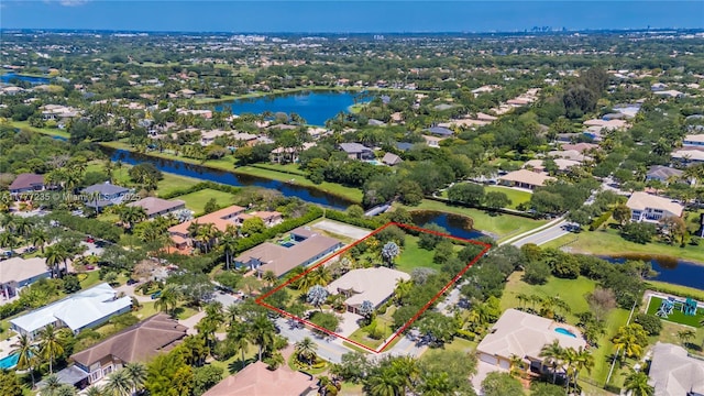 drone / aerial view with a residential view and a water view