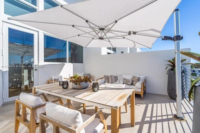 65 N Shore Dr Unit 31C, Miami Beach, FL 33141 - wooden terrace with an outdoor living space and outdoor dining space