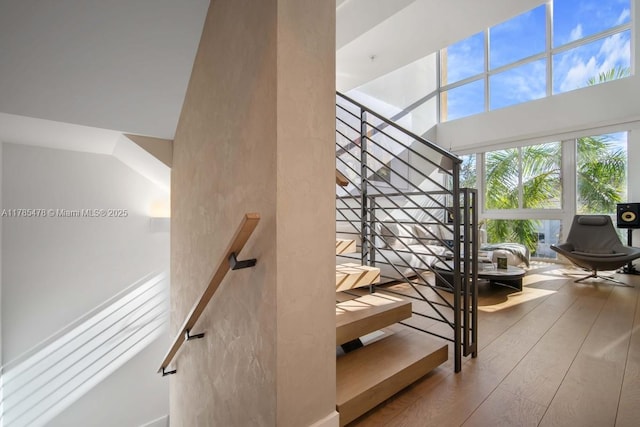 65 N Shore Dr Unit 31C, Miami Beach, FL 33141 - staircase featuring a towering ceiling and wood finished floors