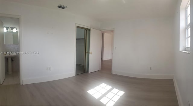 3130 SW 65th Ave, Miami, FL 33155 - unfurnished bedroom with wood finished floors, a closet, and ensuite bath