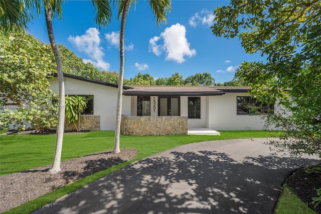 15201 SW 87th Ct, Palmetto Bay, FL 33157 - view of front facade featuring stucco siding, stone siding, and a front lawn