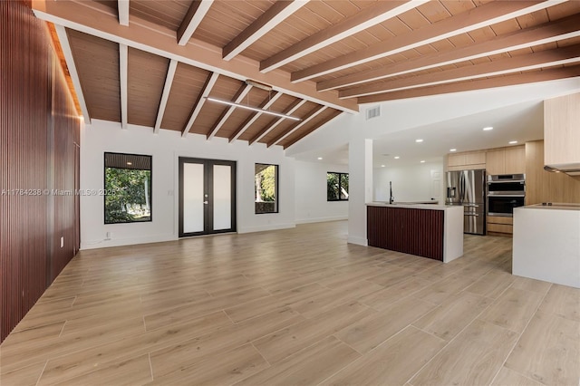 15201 SW 87th Ct, Palmetto Bay, FL 33157 - unfurnished living room with light wood finished floors, visible vents, vaulted ceiling with beams, and a healthy amount of sunlight