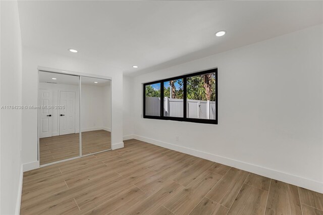 15201 SW 87th Ct, Palmetto Bay, FL 33157 - unfurnished bedroom featuring light wood-style flooring, a closet, baseboards, and recessed lighting