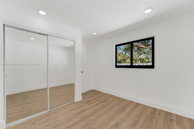 15201 SW 87th Ct, Palmetto Bay, FL 33157 - unfurnished bedroom with a closet, baseboards, recessed lighting, and light wood-style floors